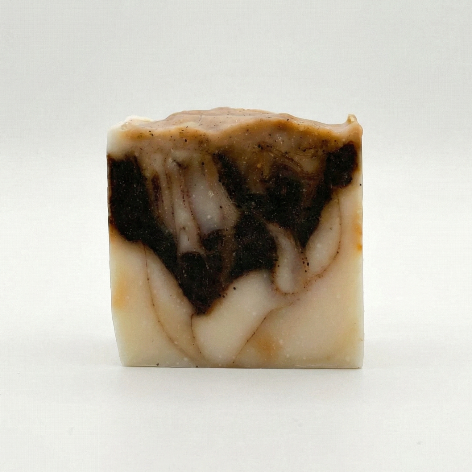 Marbled soap bar with brown and beige colors on a white background